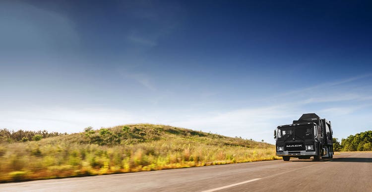 A truck driving on the road Description automatically generated